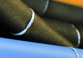 Detailed close up view on samples of cloth and fabrics in different colors found at a fabrics market photo