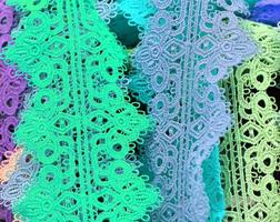 Detailed close up view on samples of cloth and fabrics in different colors found at a fabrics market photo