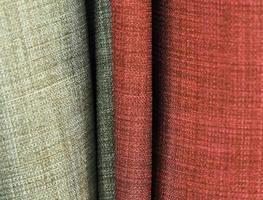 Detailed close up view on samples of cloth and fabrics in different colors found at a fabrics market photo