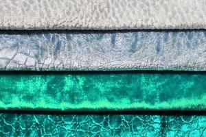 Detailed close up view on samples of cloth and fabrics in different colors found at a fabrics market photo