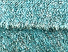 Detailed close up view on samples of cloth and fabrics in different colors found at a fabrics market photo