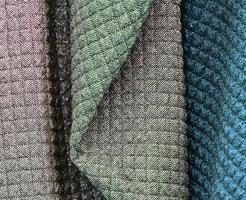 Detailed close up view on samples of cloth and fabrics in different colors found at a fabrics market photo