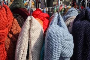 Detailed close up view on samples of cloth and fabrics in different colors found at a fabrics market photo