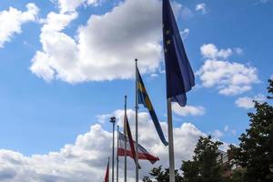 European Union flag at a flagpole moving slowly in the wind against the sky photo