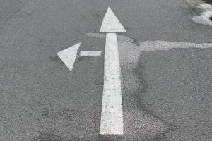 Different signs and marking painted on the ashpalt of streets and roads. photo