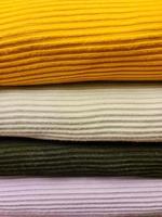 Detailed close up view on samples of cloth and fabrics in different colors found at a fabrics market photo