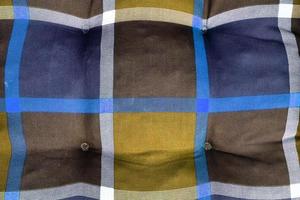 Detailed close up view on samples of cloth and fabrics in different colors found at a fabrics market photo
