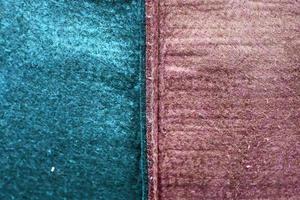 Detailed close up view on samples of cloth and fabrics in different colors found at a fabrics market photo