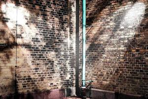 Aged and weathered brick wall textures with very bright spotlight illumination photo