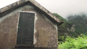 Wooden door on simple stone house structure video
