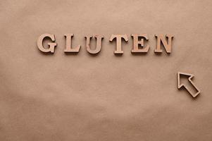 Gluten.Text in block letters on a paper background. Free space for design. photo