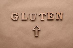 Gluten.Text in block letters on a paper background. Free space for design. photo