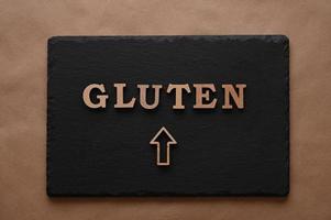 Gluten.Text in block letters on a paper background. Free space for design. photo