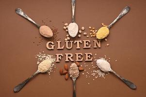 Gluten free text and spoons of various gluten free flour. Flat lay, top. photo