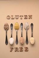 Gluten free text and spoons of various gluten free flour. Flat lay, top. photo