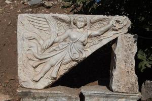 Stone carving of the goddess Nike in Ephesus Ancient City photo