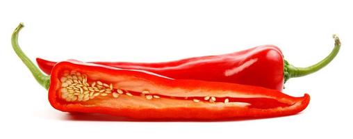 Two pods of red pepper, a whole and half are isolated on a white background. photo