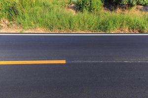 White and yellow line on new asphalt road photo