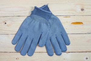 Gloves on wooden background top view photo