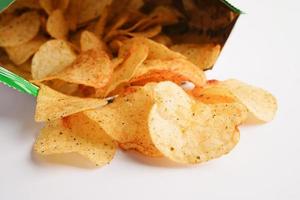 Potato chips in open bag, delicious BBQ seasoning spicy for crips, thin slice deep fried snack fast food in open bag. photo