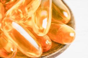 Fish oil or Cod liver oil gel in capsules with omega 3 vitamins, supplementary healthy food photo