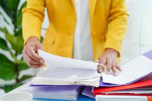 Businessman working and prepare paperwork report data to analysis information in file binder at office. photo