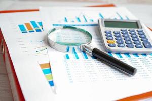 Calculator on chart and graph spreadsheet paper. Finance development, Banking Account, Statistics, Investment Analytic research data economy, Stock exchange trading, Business company concept. photo