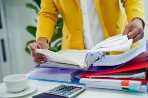 Businessman working and prepare paperwork report data to analysis information in file binder at office. photo