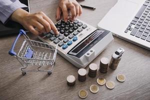 Close up of hand putting coin on pile coins for saving money. Collect money to buy a new car, saving and car loan concept. Flat lay photo