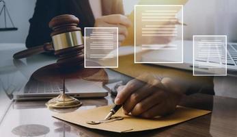 Business and lawyers discussing contract papers with brass scale on desk in office. Law, legal services, advice, justice and law concept photo