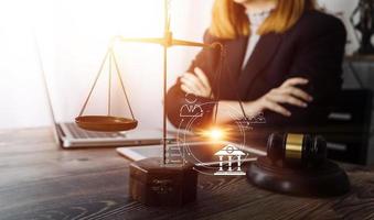 Business and lawyers discussing contract papers with brass scale on desk in office. Law, legal services, advice, justice and law concept picture with film grain effect photo