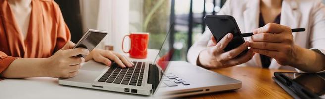 Businessman and team analyzing financial statement Finance task. with smart phone and laptop and tablet. Wealth management concept photo