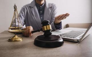 Male lawyer working with contract papers and wooden gavel on tabel in courtroom. justice and law ,attorney, court judge, concept. photo