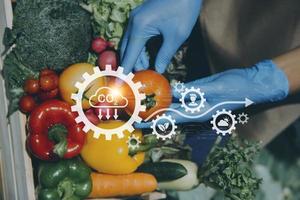 Futuristic businessman farms vegetables and crops using modern AI technology using mobile phones, temperature and humidity sensors, water tracking, climate control, holographic data data icons. photo