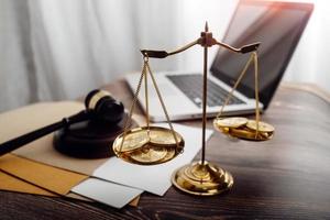 Business and lawyers discussing contract papers with brass scale on desk in office. Law, legal services, advice, justice and law concept picture with film grain effect photo