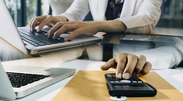 Businessman and team analyzing financial statement Finance task. with smart phone and laptop and tablet. Wealth management concept photo