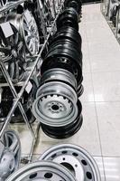 Auto shop selling car rims. Stand for sale of alloy wheels. Discounts at auto parts store. photo