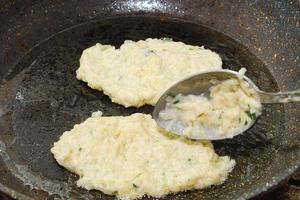 Recipe for zucchini fritters. Step 4 - Putting dough on hot pan with oil. photo