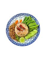 Chili Paste Fried Rice Served with fresh vegetables and salted egg. Isolated on white background. Thai food. photo