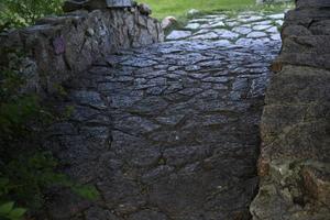 A stone bridge in a garden park in the city. A bridge for lovers in the city. photo