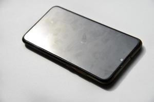 A black smartphone on a white background. photo