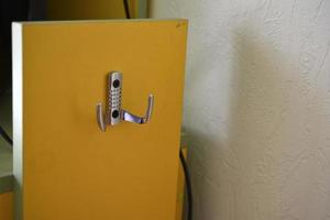 Yellow hanger indoors at home with silver handles photo