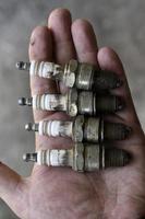 Spark plugs are dirty in the palm of your hand photo