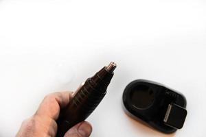 Razor for cutting hair in the nose and ears on a white background photo