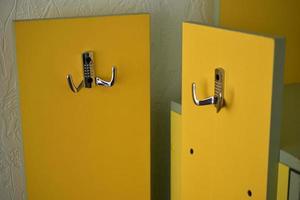 Yellow hanger indoors at home with silver handles photo