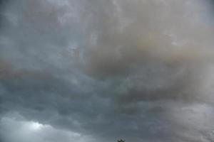 Black thunderstorm storm clouds on a summer day. Beautiful terrible thunderstorm. photo