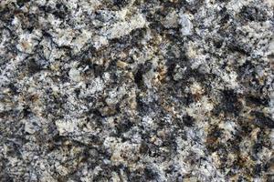 Beautiful background of gray-red granite. Granite stone close-up. photo