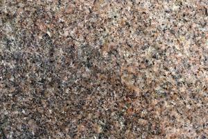 Beautiful background of gray-red granite. Granite stone close-up. photo