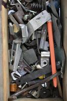 Old hardware parts, screws and nails. In an old wooden box. photo