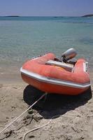 Red boat in front of the clear water at Elafonisi, Crete, Greece photo